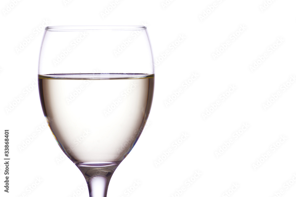 White wine in a glass, white background. White wine in a glass, white background.