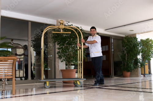 Tapeta Bellboy with luggage cart.