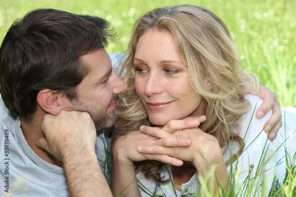 Loving couple embracing in a meadow Loving couple embracing in a meadow