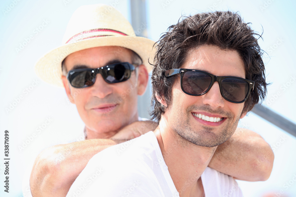 Father and son wearing sunglasses Father and son wearing sunglasses