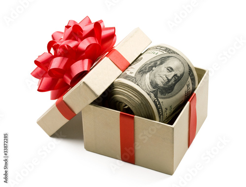 Holiday bonus. Money roll in gift box with red bow.