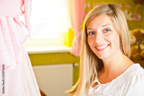 Pregnant woman in baby room