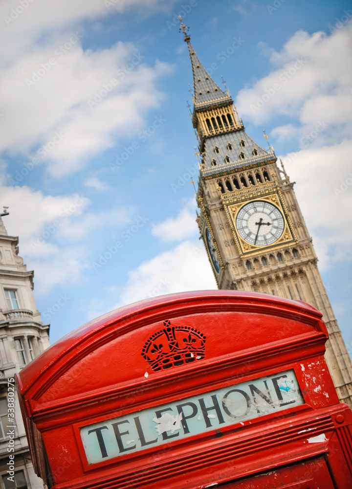 Top of British red telephone box and Big Ben in background in London, UK
