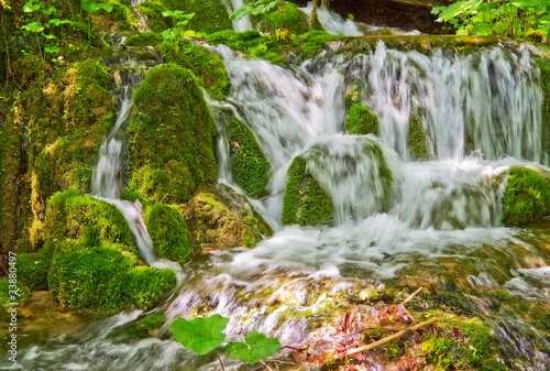 Fototapeta Naklejka Na Ścianę i Meble -  Water flowing over mossy rocks.