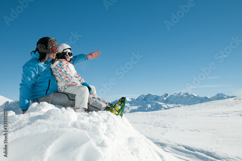 Winter vacation - little girl with father in ski resort