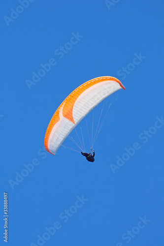 paraglider on blue sky