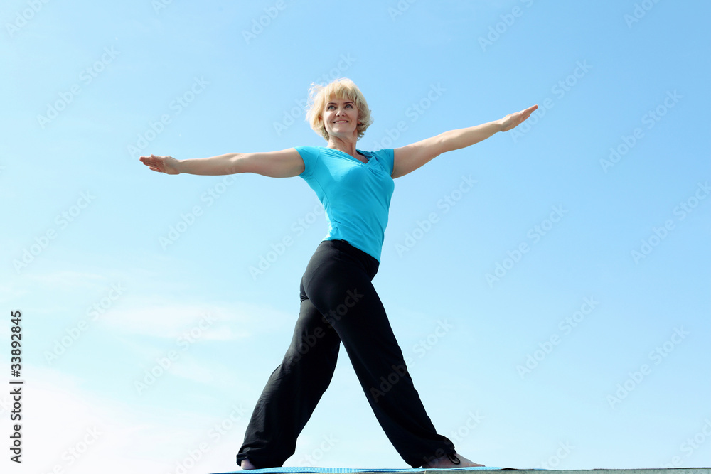 Fototapeta premium Portrait of a senior woman doing yoga