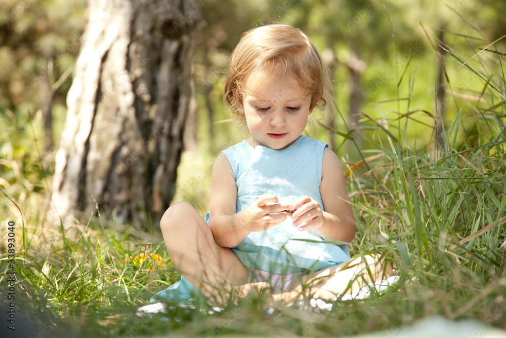 cute little girl smiling in a park cute little girl smiling in a park