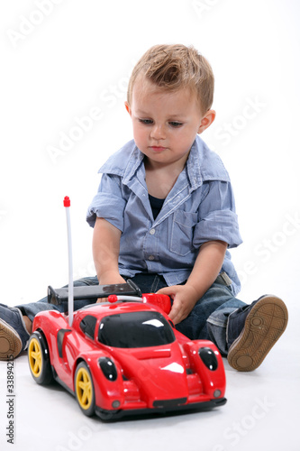 Little boy with a remote controlled car