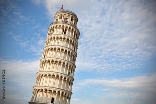 Leaning tower of Pisa at sunset, with cloudy blue skies
