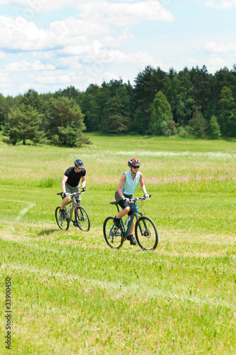 Sport happy couple riding bicycles in coutryside