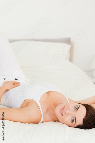 Portrait of a cute woman lying on her back
