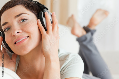 Close up of a smiling brunette listening to music