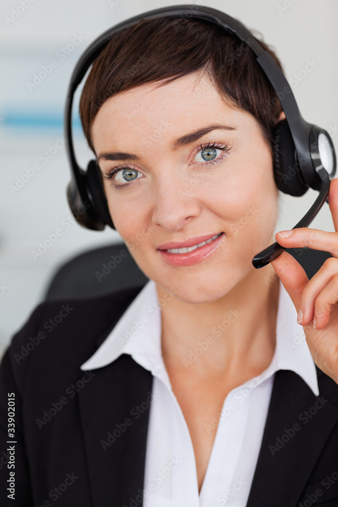 Portrait of a cute secretary calling with a headset Portrait of a cute secretary calling with a headset