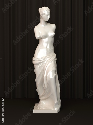 Ancient marble Statue of a nude Venus isolated on dark photo