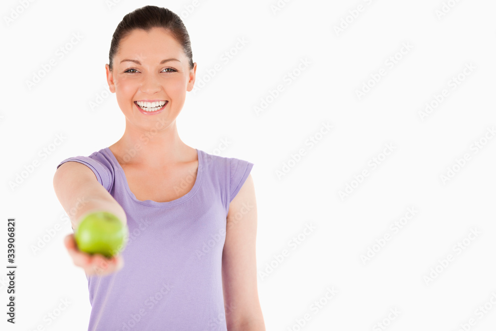 Gorgeous woman holding an apple while standing Gorgeous woman holding an apple while standing