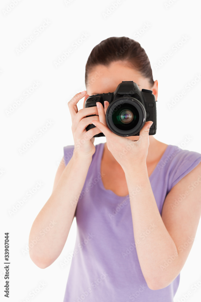 Charming female using a camera while standing Charming female using a camera while standing