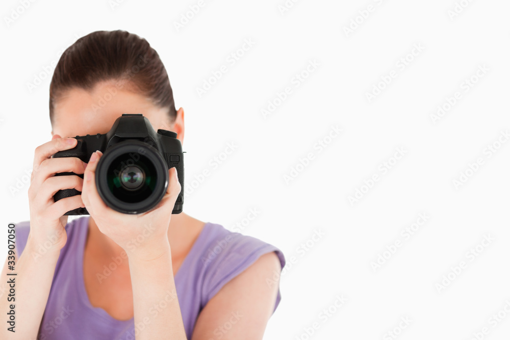 Beautiful female using a camera while standing Beautiful female using a camera while standing