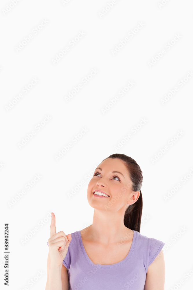 Good looking female pointing at a copy space Good looking female pointing at a copy space