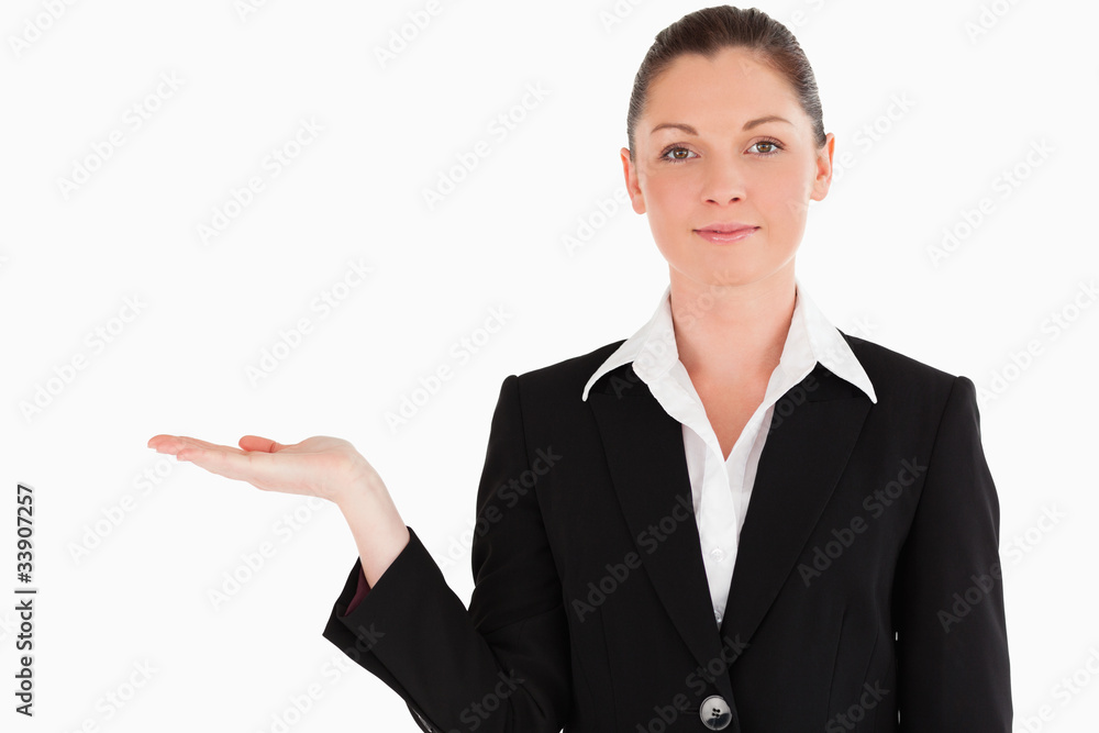 Lovely woman in suit showing a copy space while standing