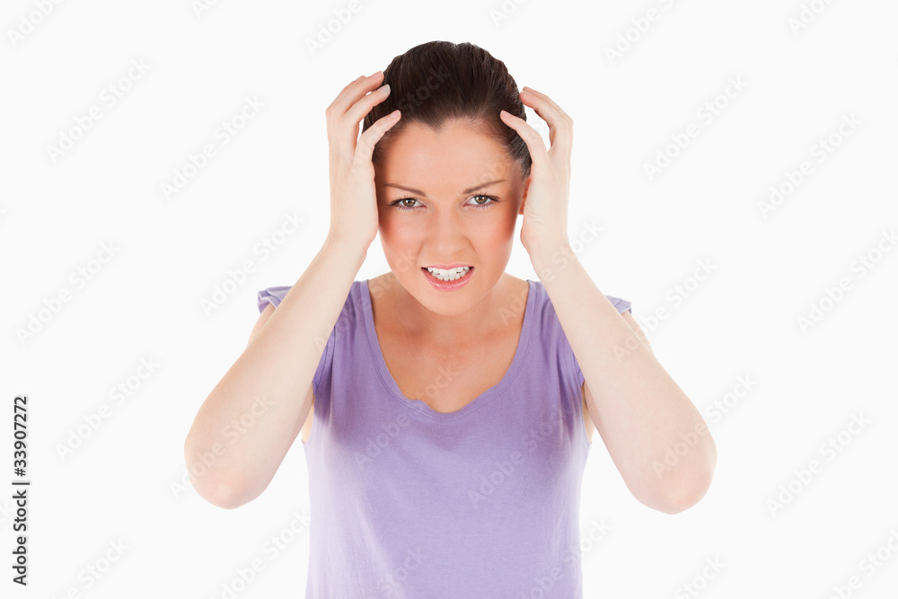 Attractive woman having a migraine while standing Attractive woman having a migraine while standing