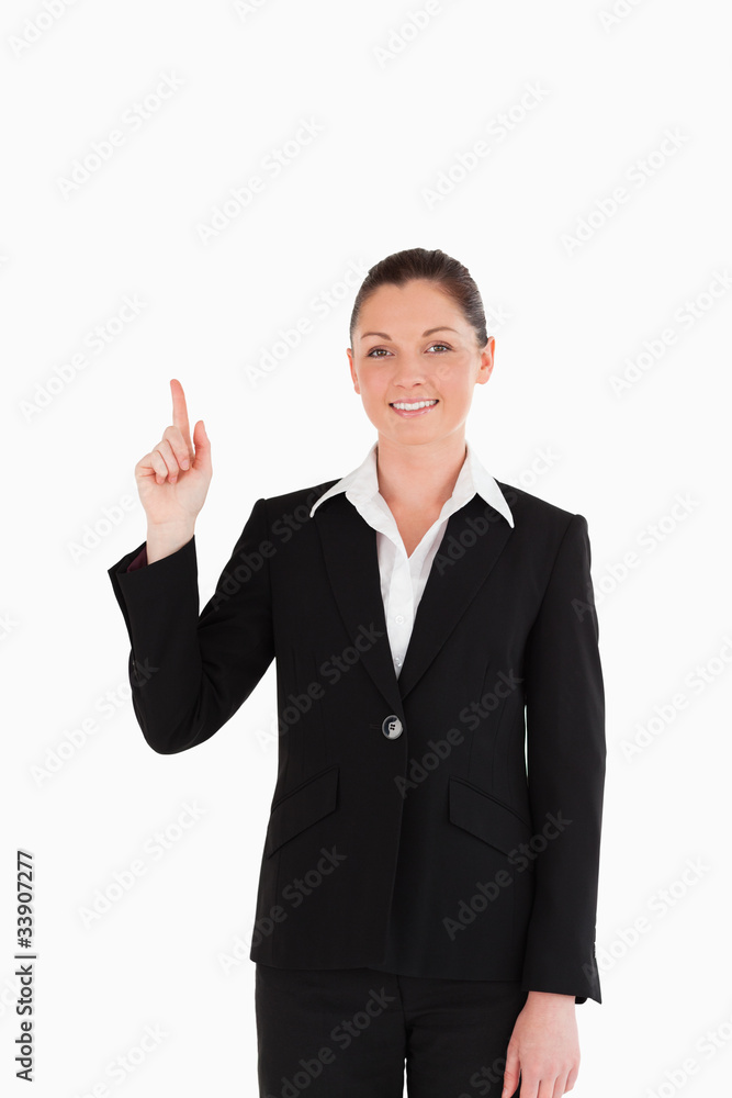 Cute woman in suit pointing at a copy space Cute woman in suit pointing at a copy space