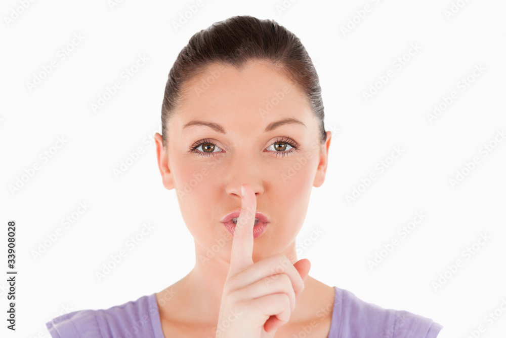 Portrait of a beautiful woman doing hush while standing Portrait of a beautiful woman doing hush while standing