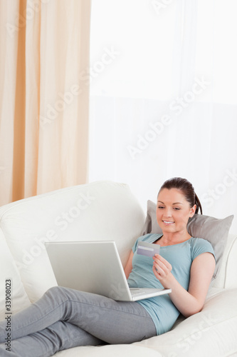Good looking female making an online payment with her credit car