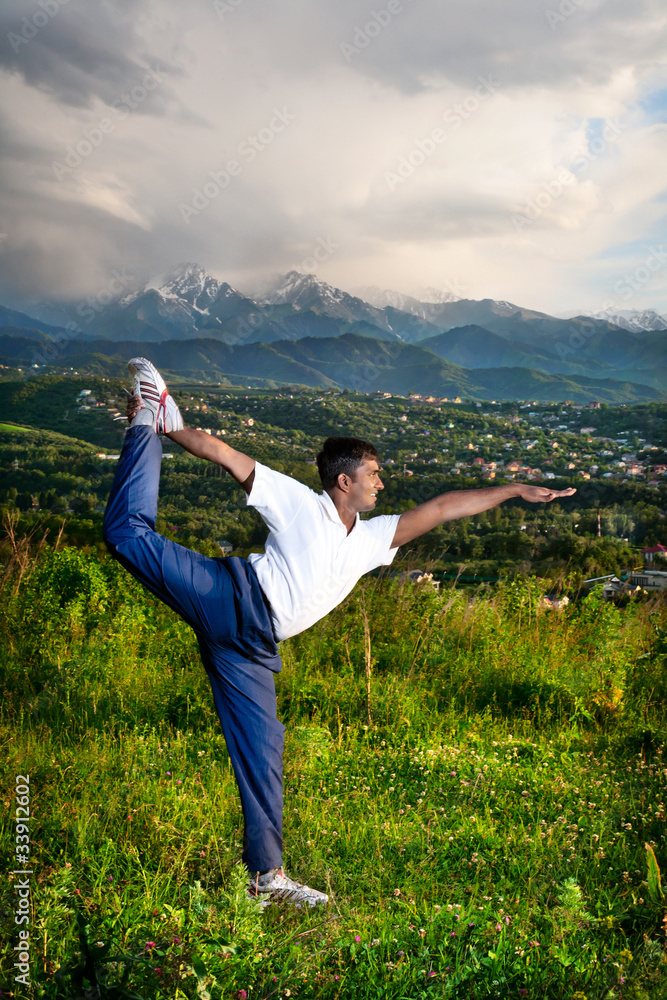 Yoga natarajasana dancer pose in mountains