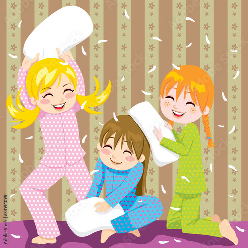 Three young girls having fun in pillow fight