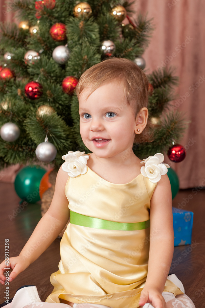 Little lady in gold at the christmas tree Little lady in gold at the christmas tree