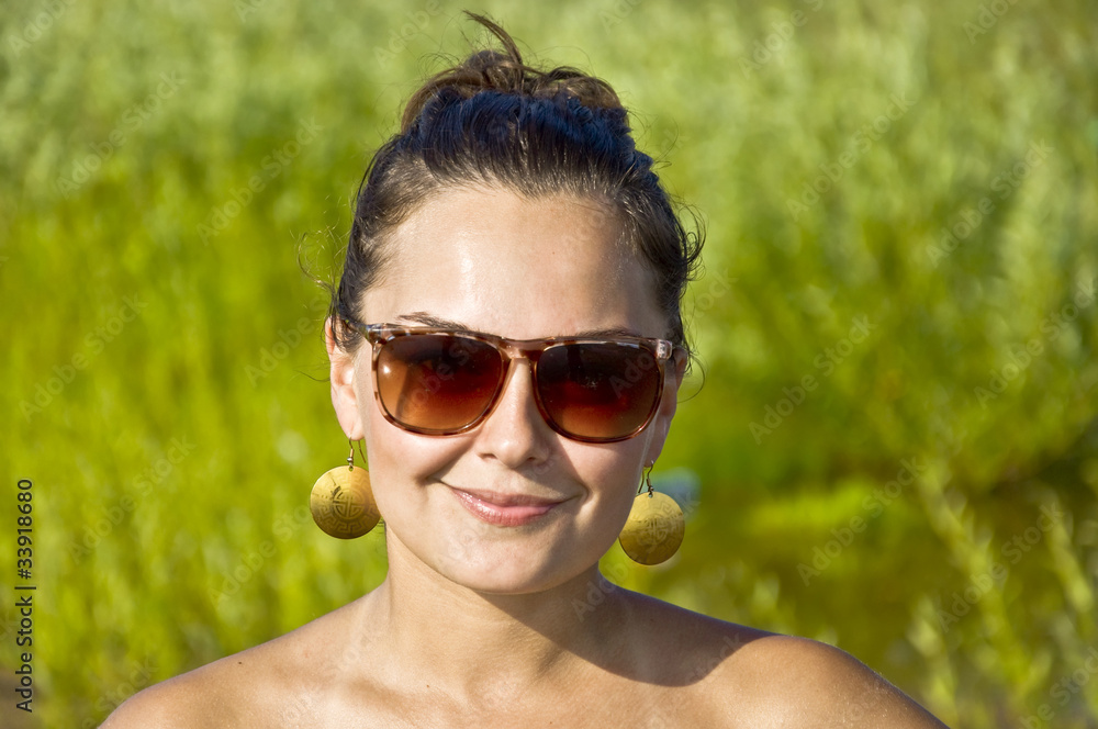 Beautiful young girl in sunglasses on the beach. Portrait. Beautiful young girl in sunglasses on the beach. Portrait.