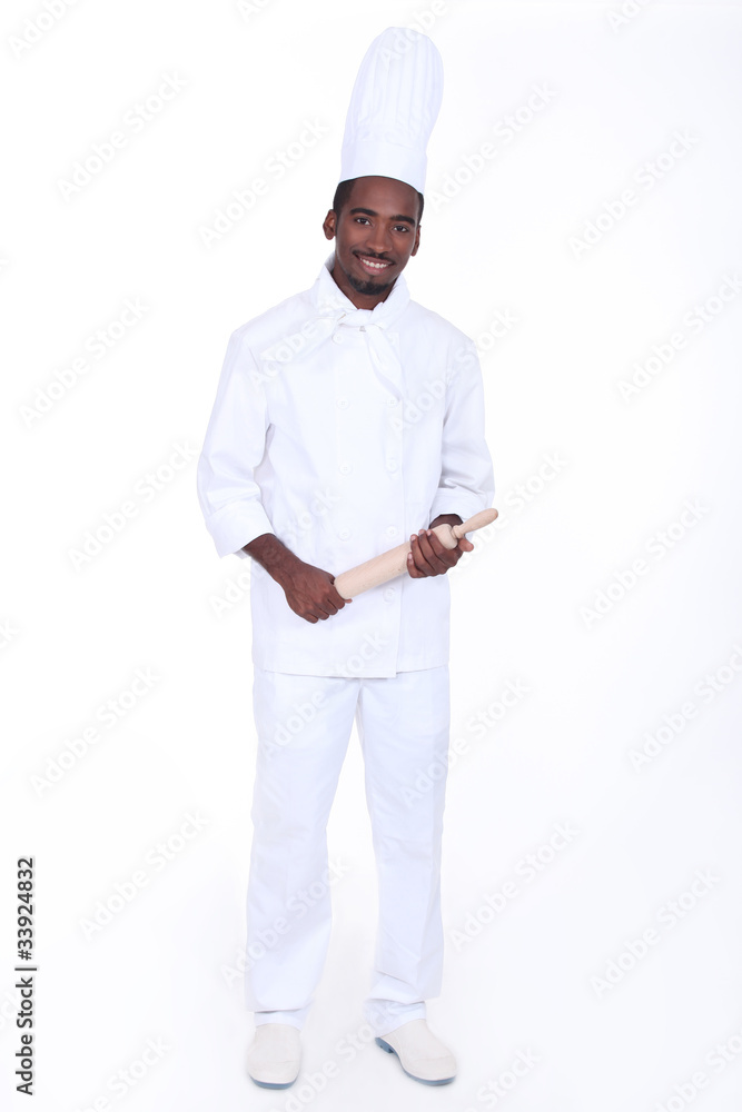 Happy male chef holding rolling pin