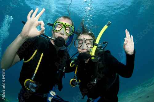 Scuba divers make OK sign underwater