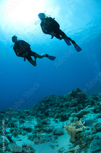 Scuba divers shilouetted © JonMilnes