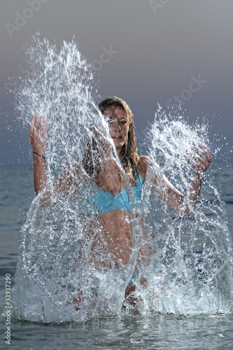 Beautiful woman jumps out of the sea