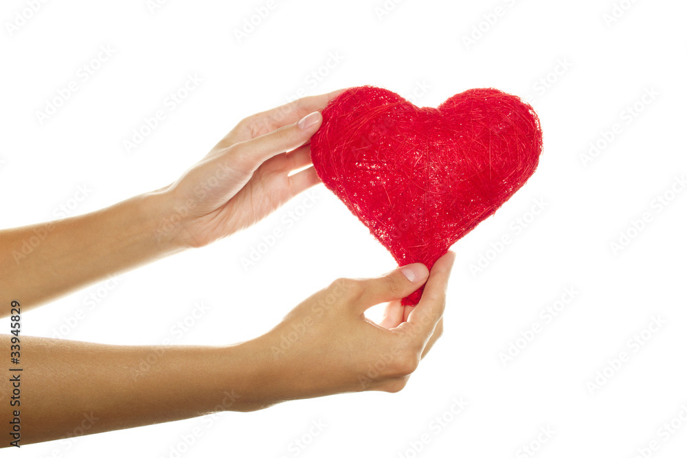 Fototapeta premium Female hands holding a red heart