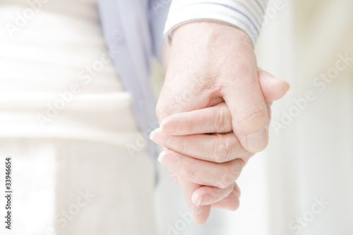 手を握る老夫婦の手元