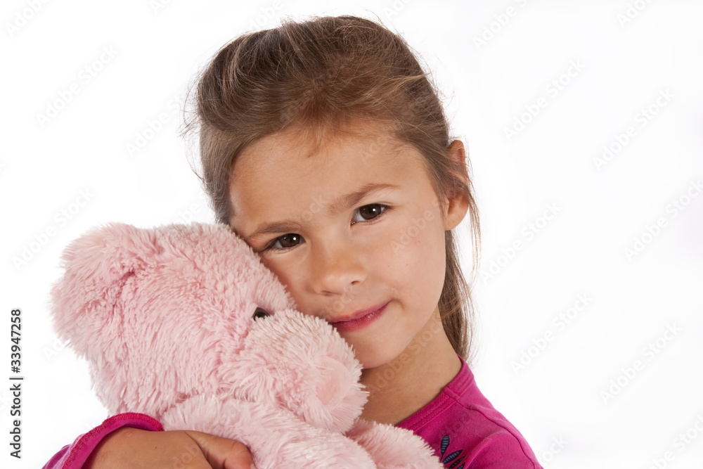 Young girl with pink dress hug teddy in studio Young girl with pink dress hug teddy in studio