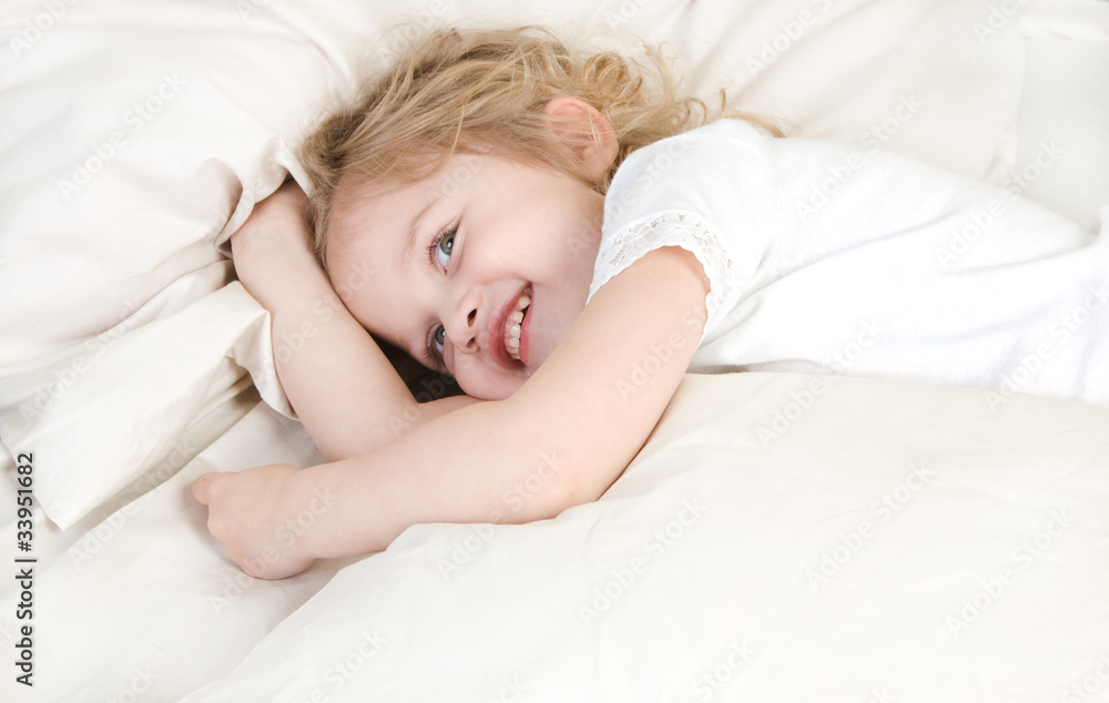 Adorable little girl resting in the bed Adorable little girl resting in the bed