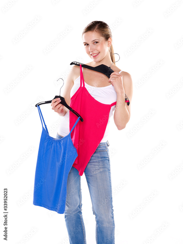 Shopping scene: young woman trying on different cloths / tops Shopping scene: young woman trying on different cloths / tops