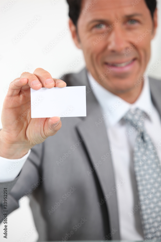 Man holding up a business card left blank for your image or text Man holding up a business card left blank for your image or text