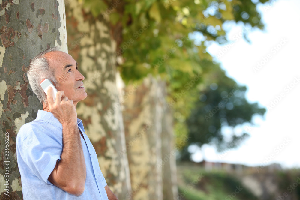 Older man outdoors with a cellphone Older man outdoors with a cellphone