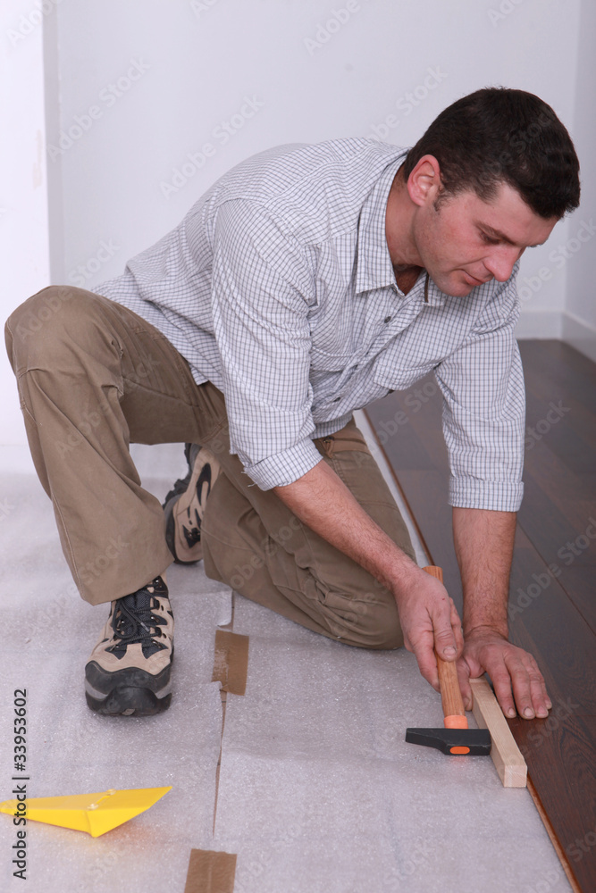 Man laying a wooden floor Man laying a wooden floor