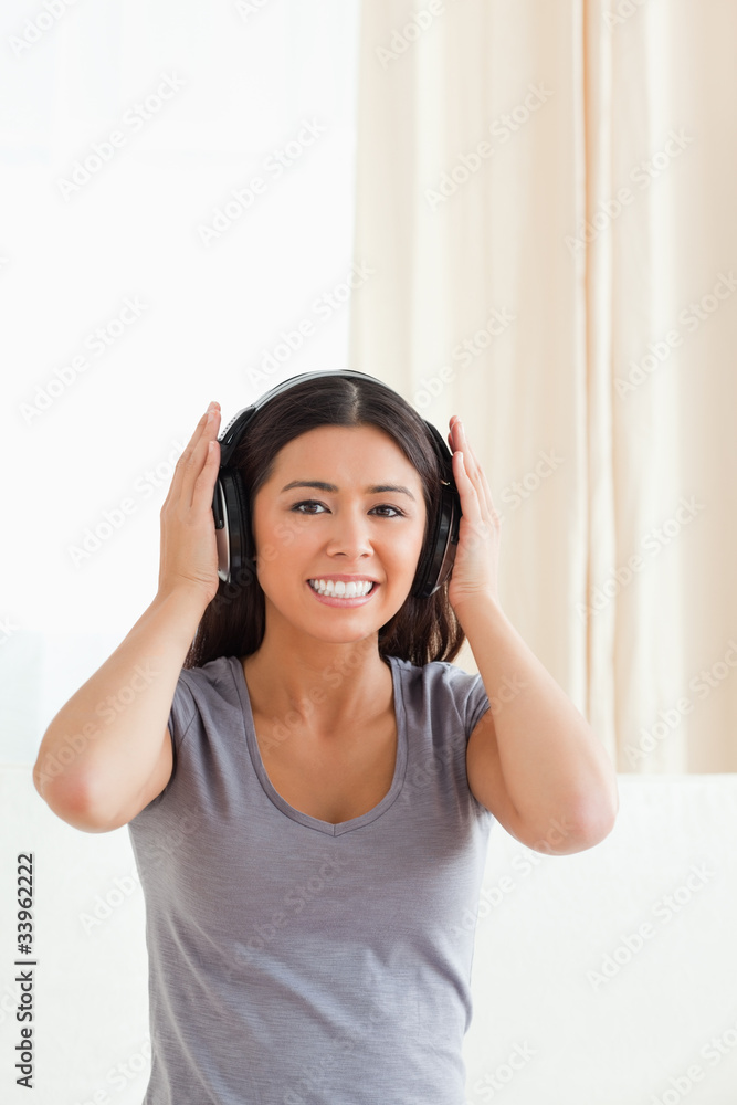 smiling woman with earphones looking into camera smiling woman with earphones looking into camera