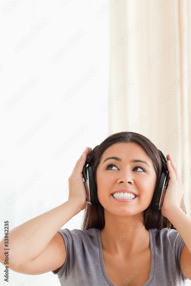 cute woman with earphones looking up cute woman with earphones looking up