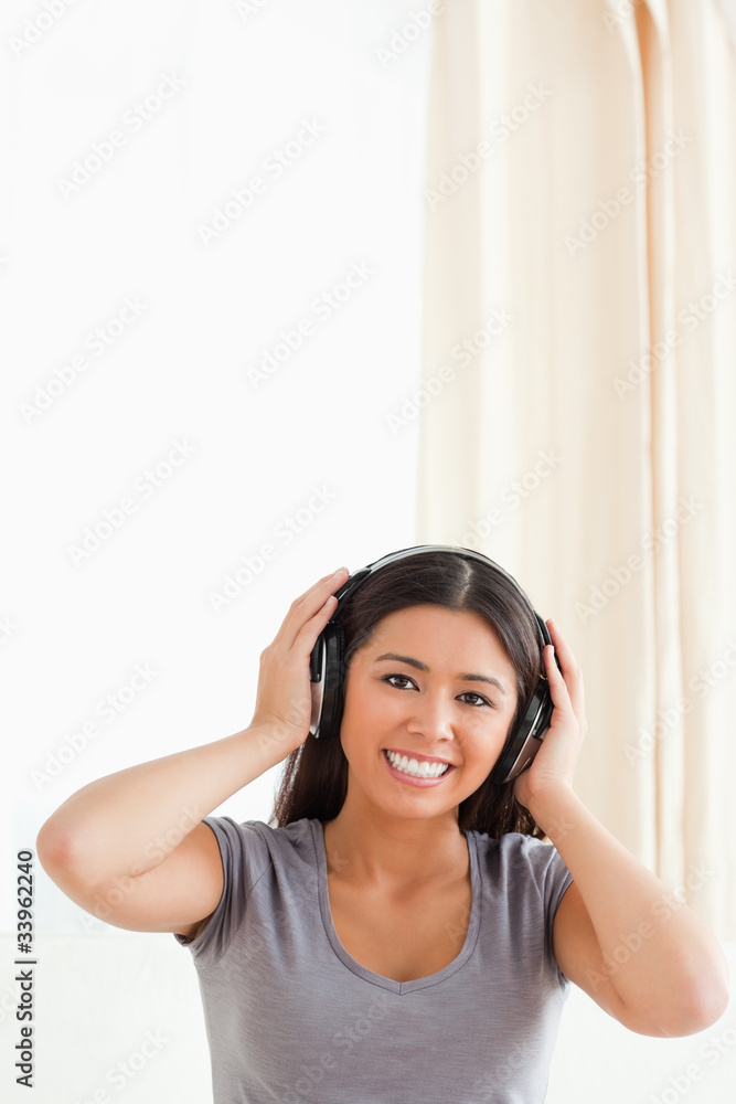 cute woman with earphones looking into camera cute woman with earphones looking into camera