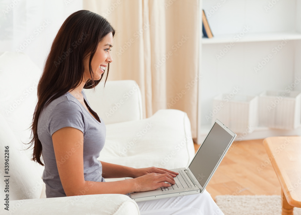 charming woman sitting on sofa with notebook charming woman sitting on sofa with notebook
