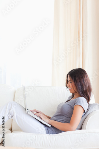 dark-haired woman sitting on sofa