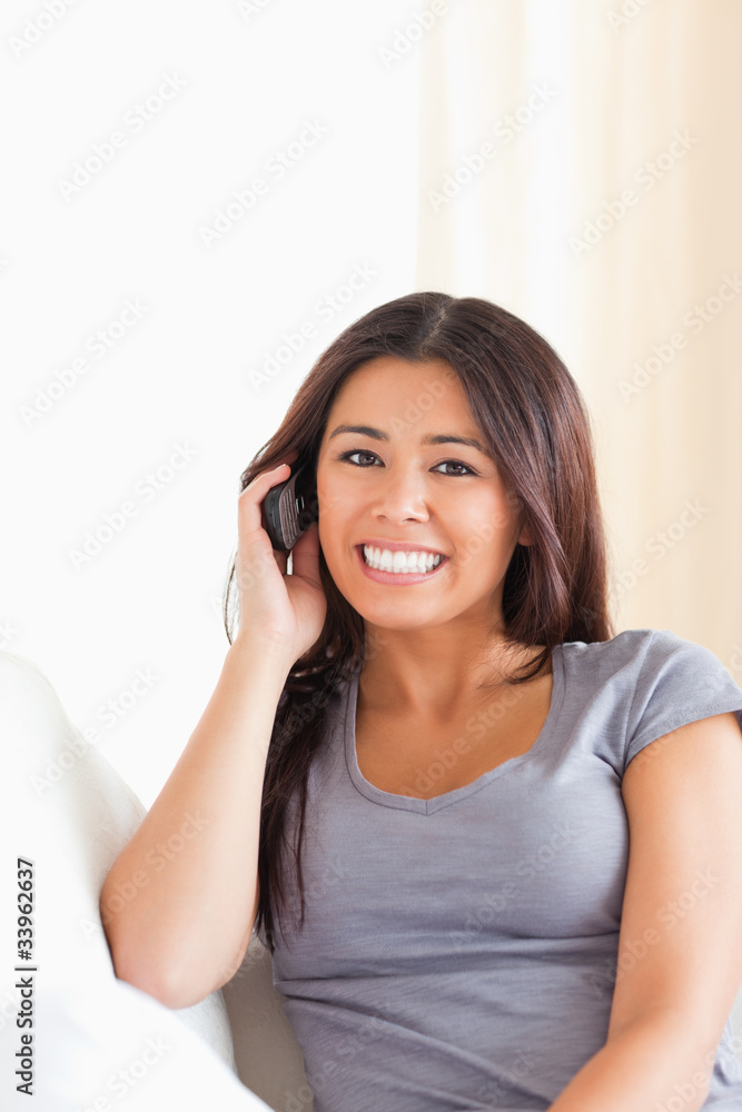 dark-haired woman phoning looking into camera dark-haired woman phoning looking into camera